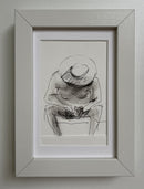 A man in a hat on the beach is busy with the phone-2