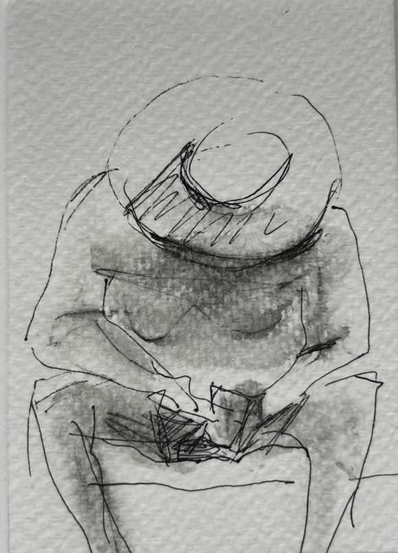 A man in a hat on the beach is busy with the phone